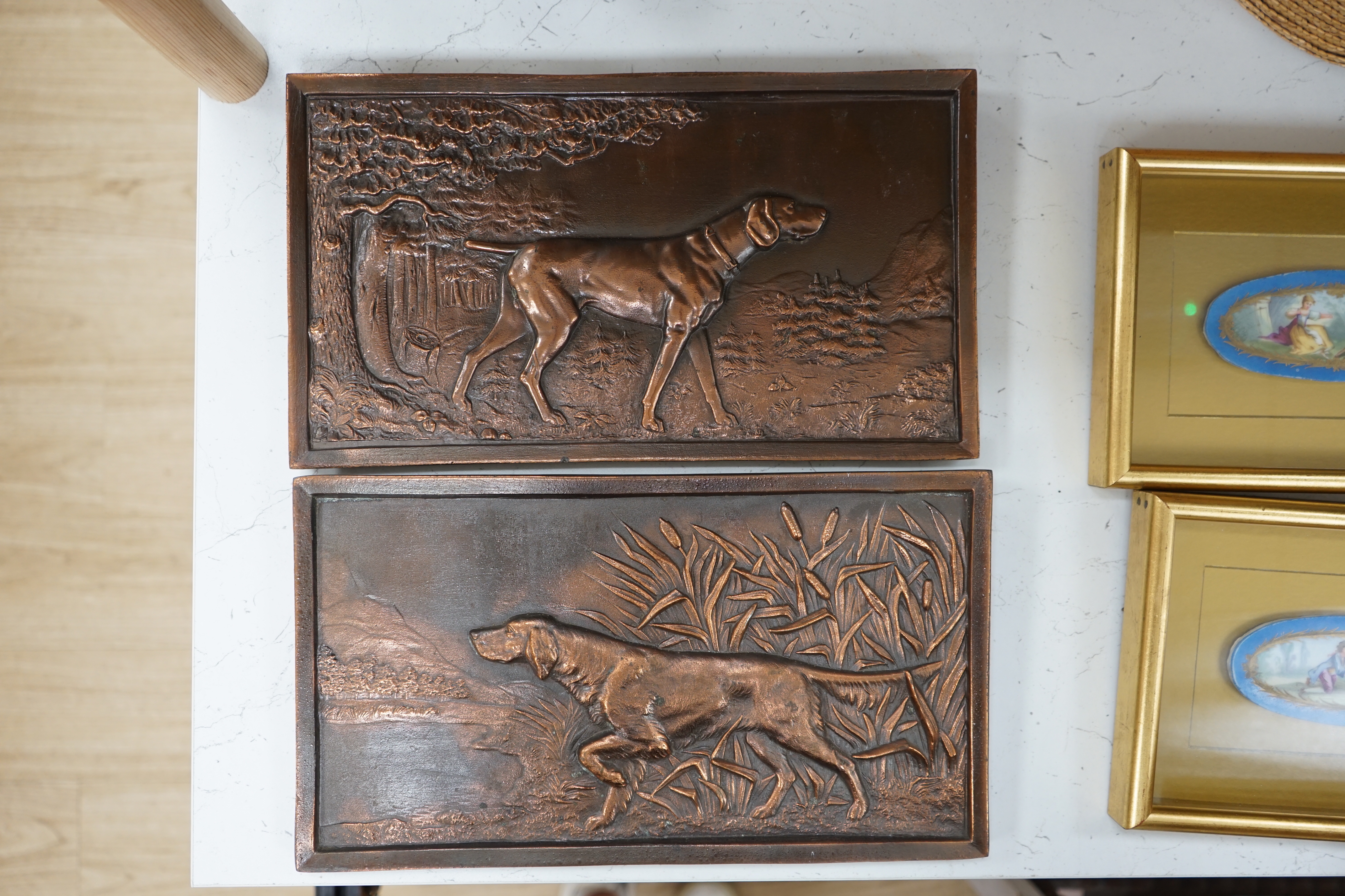 A pair of cast metal plaques of retrievers, 21 x 37cm